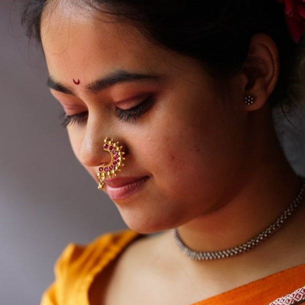 a close up of a woman with a nose ring