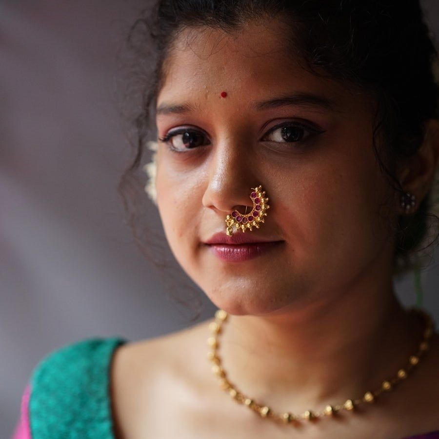 a close up of a woman with a nose ring