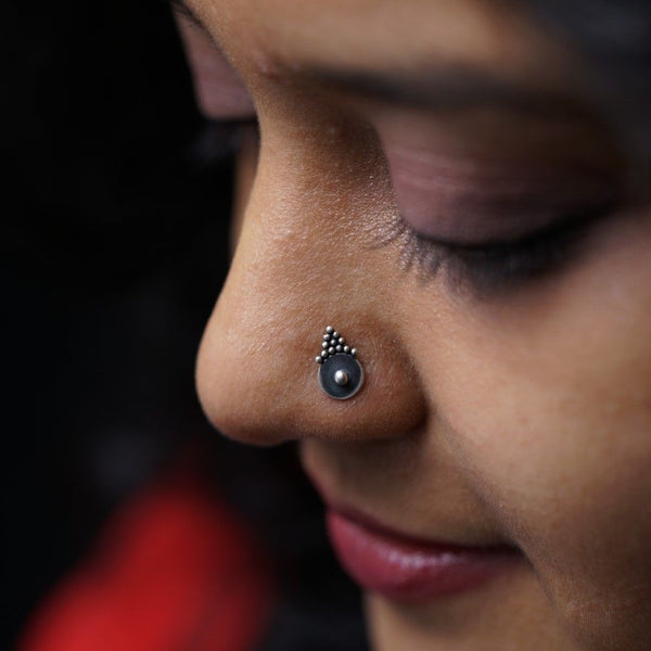 a close up of a person with a nose piercing