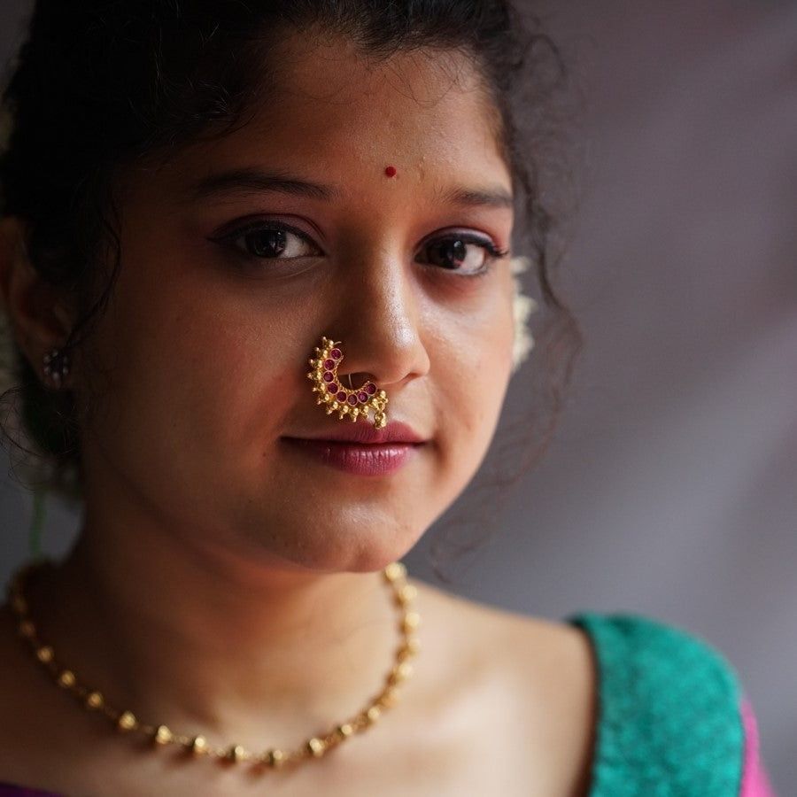 a woman with a nose ring on her nose