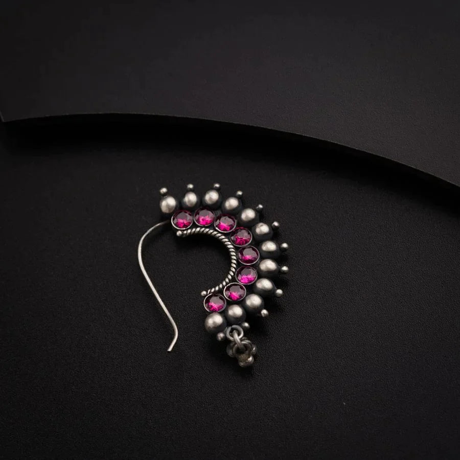 a close up of a pair of earrings on a black surface