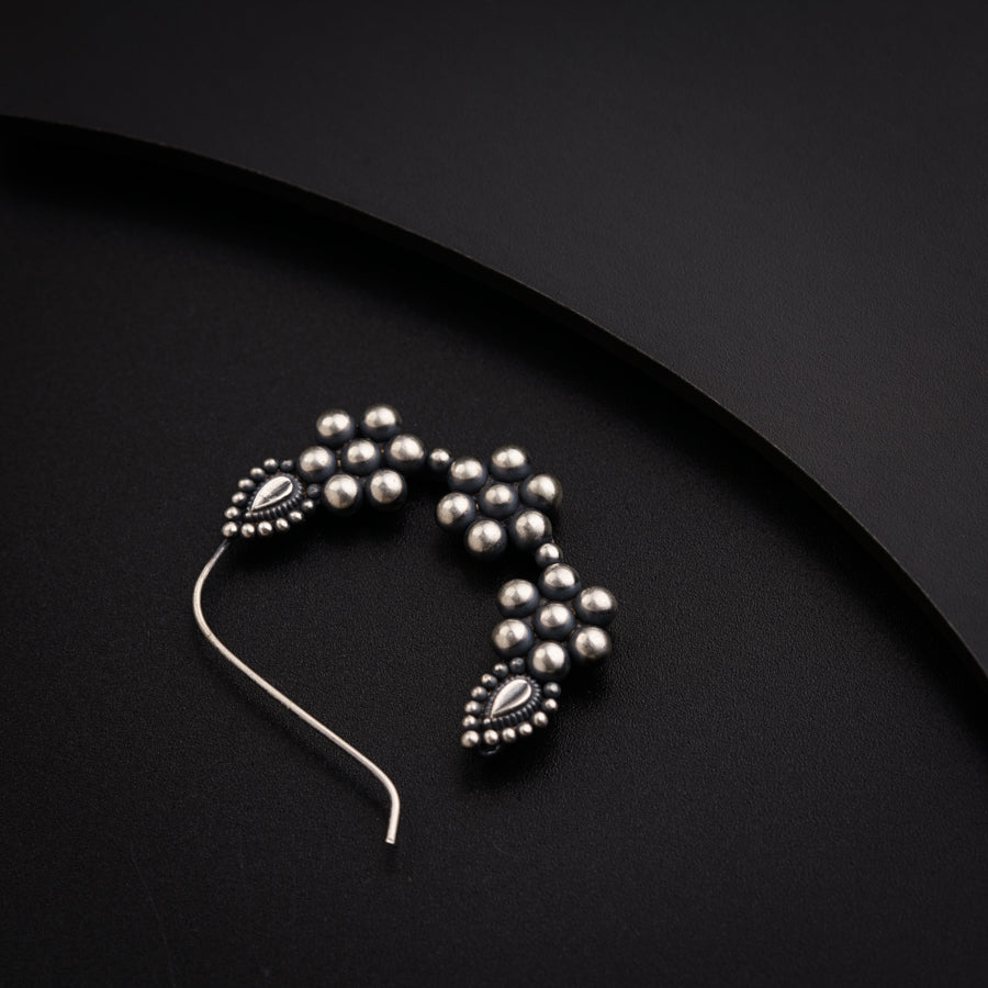 a close up of a hair pin on a black surface