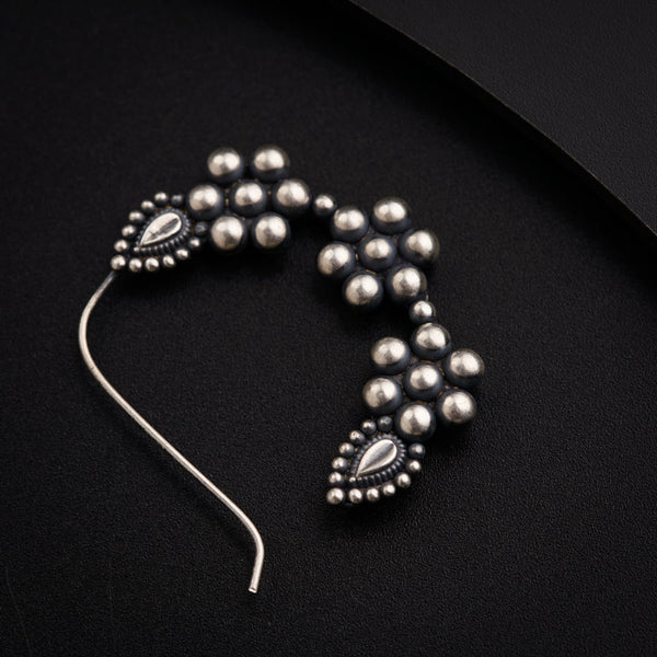 a close up of a metal object on a black surface