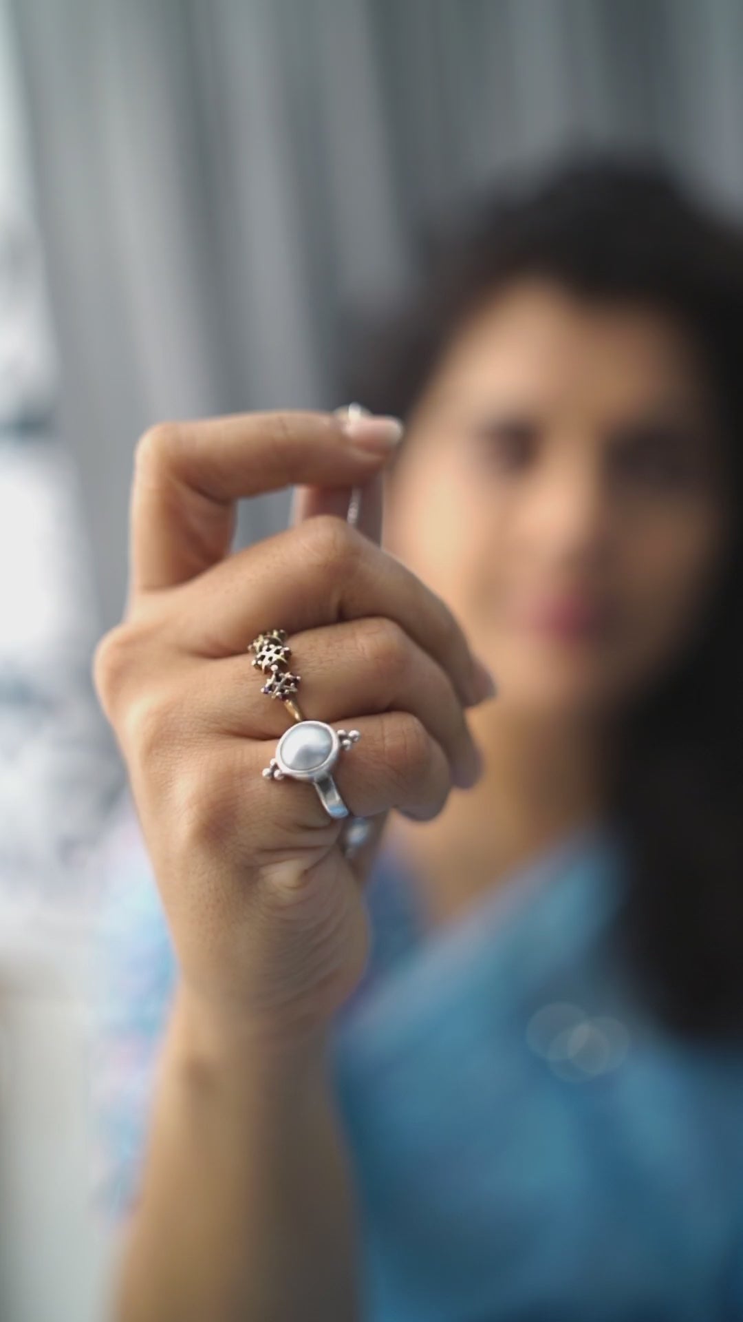 a woman holding a ring in her right hand