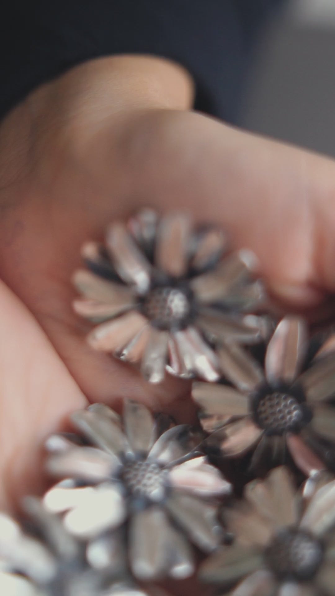 a person holding a bunch of flowers in their hands
