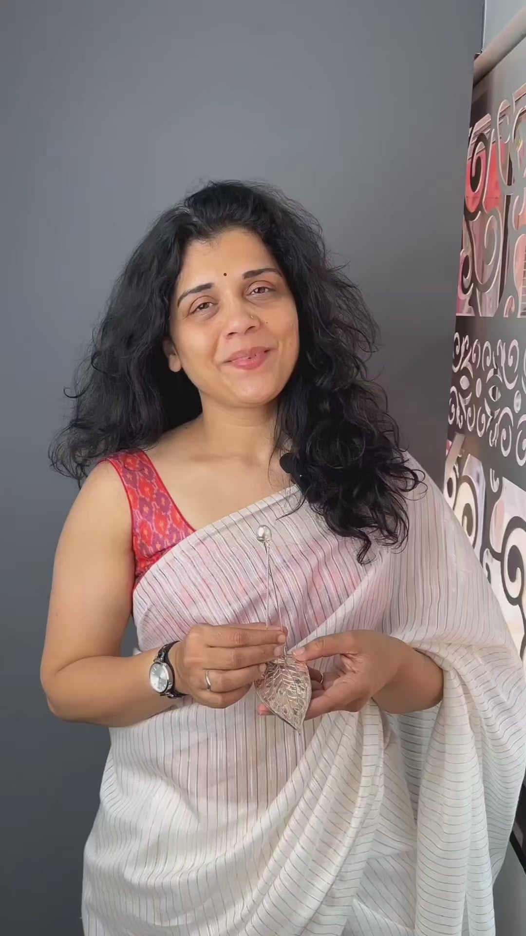 a woman in a white sari holding a piece of paper