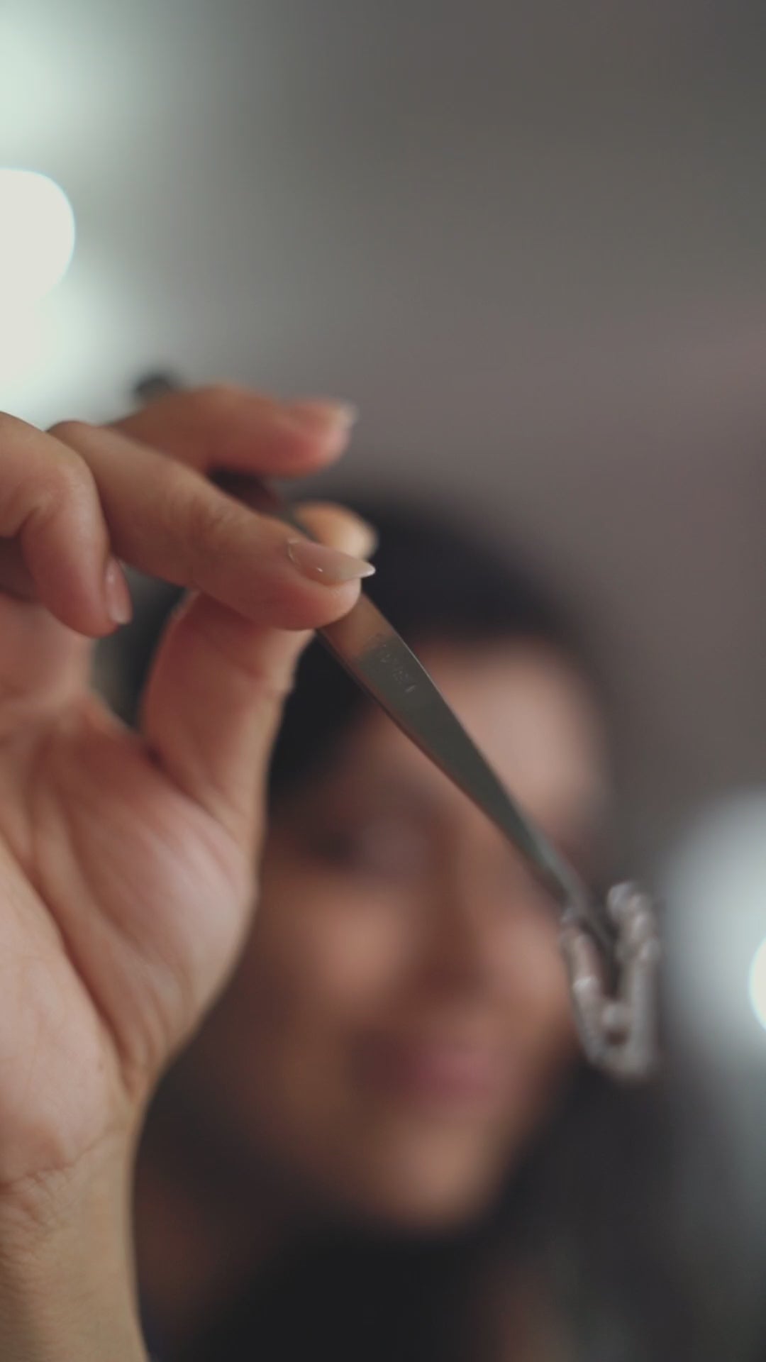 a woman holding a pair of scissors in her hand