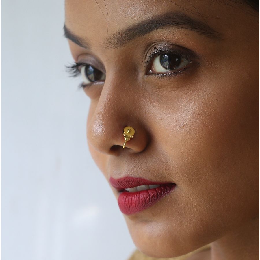 a close up of a woman with a nose ring