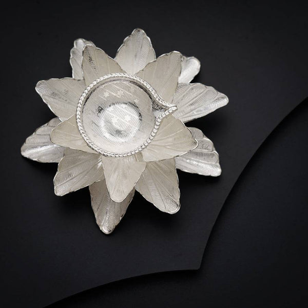 Close-up of silver diya with intricate design