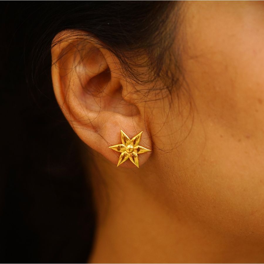a close up of a person wearing a pair of earrings
