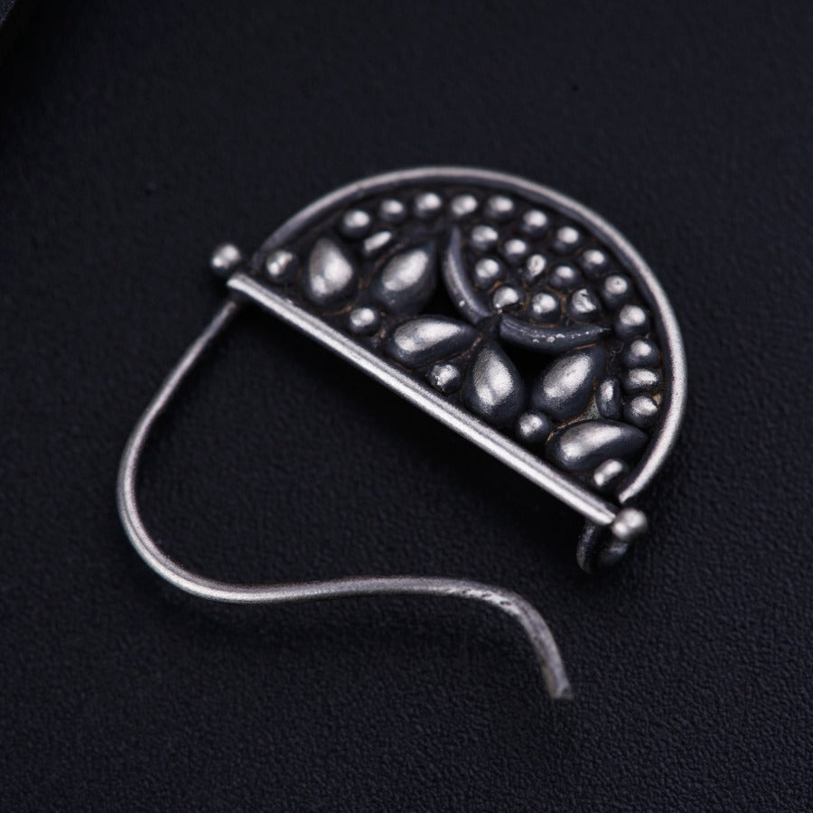 a close up of a metal object on a black surface