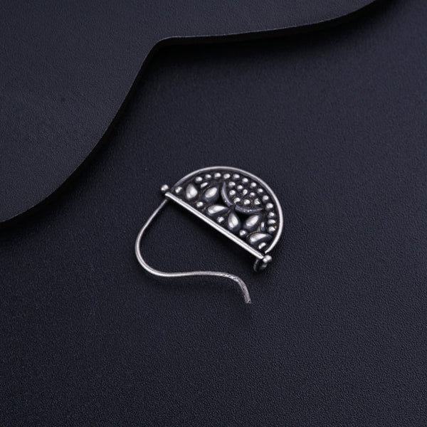 a piece of metal sitting on top of a black surface