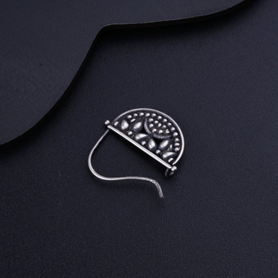 a piece of metal sitting on top of a black surface