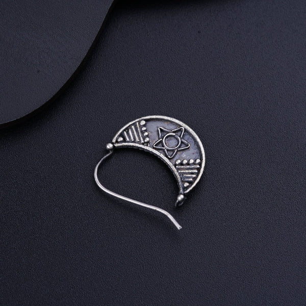 a silver brooch with a design on it
