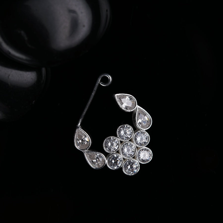 a close up of a pair of earrings on a black surface