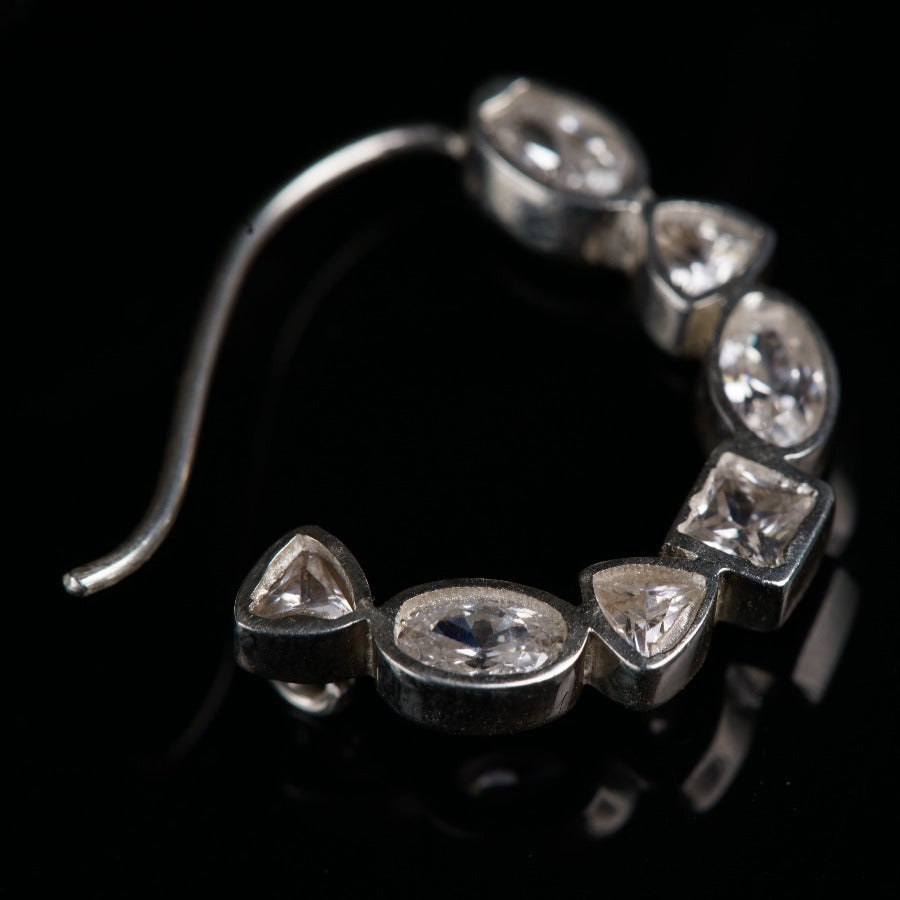 a close up of a metal object on a black surface