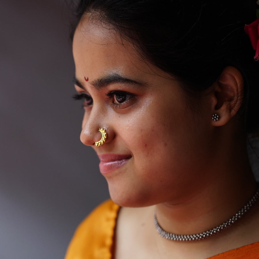 a close up of a woman with a nose piercing