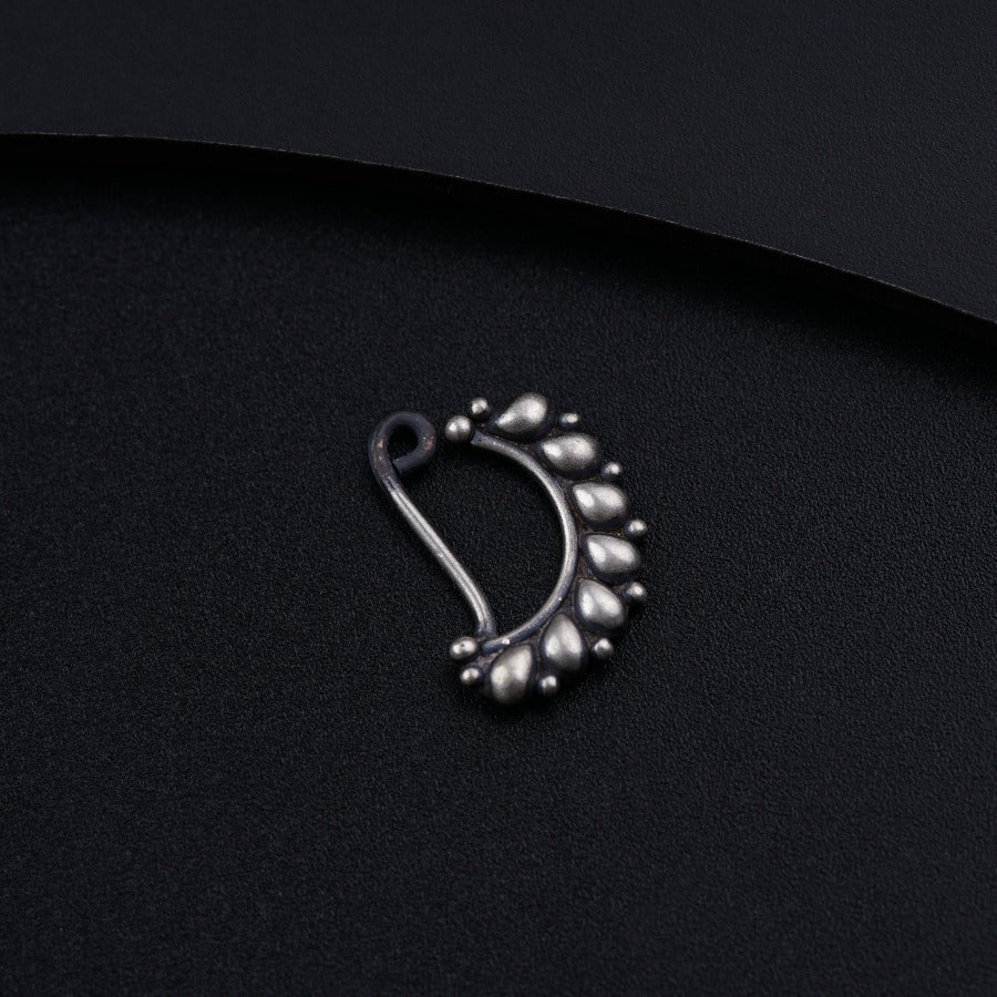 a close up of a metal object on a black surface