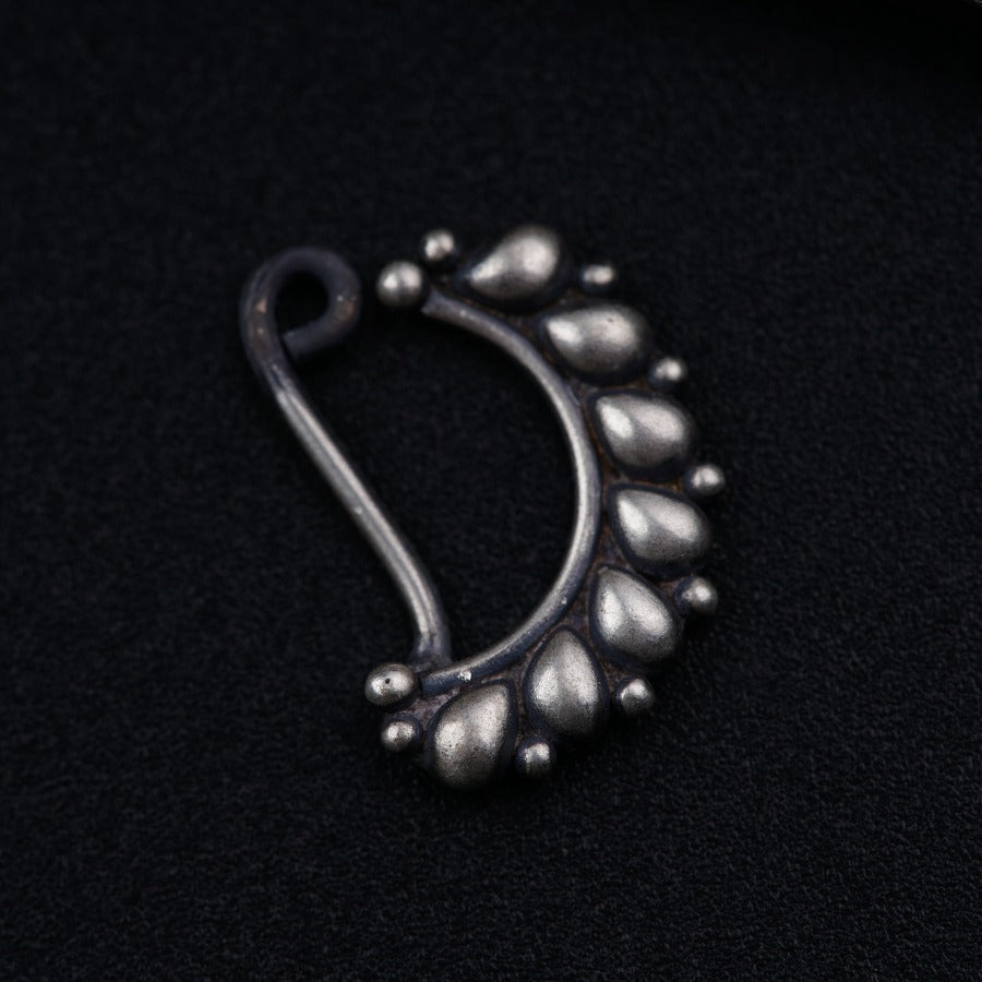 a close up of a metal object on a black surface