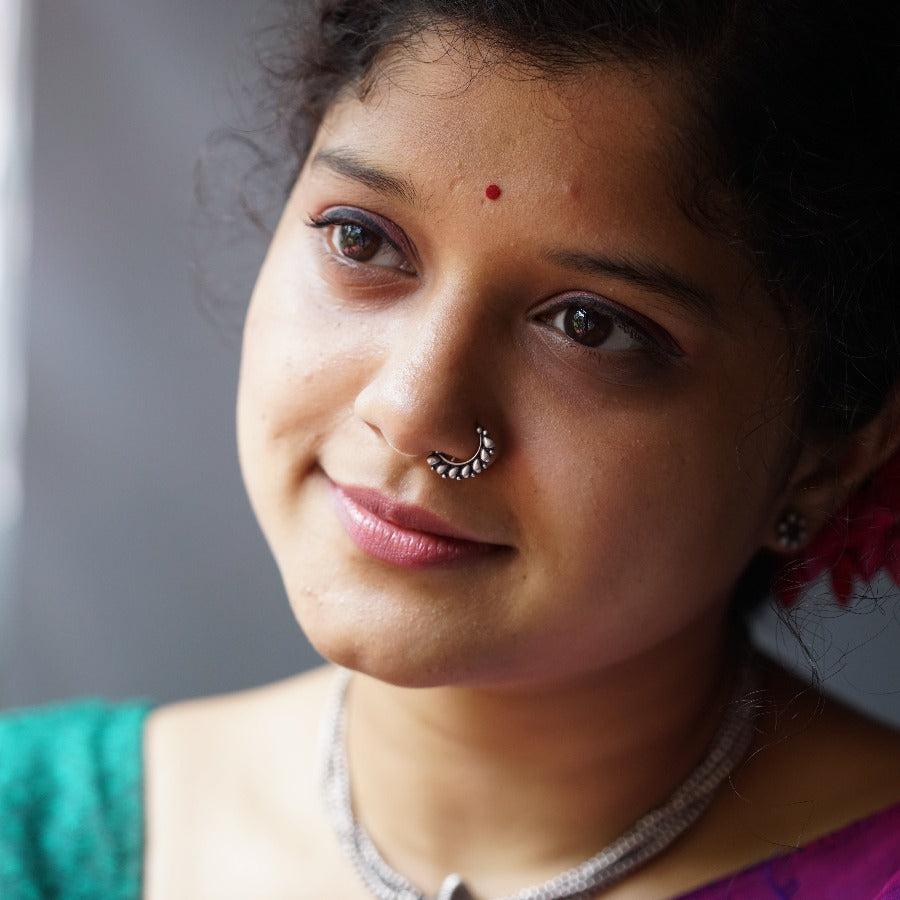 a close up of a woman with a nose ring