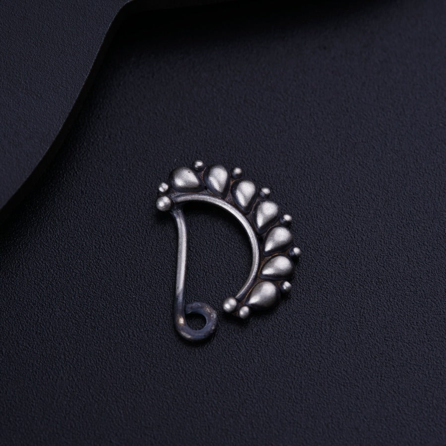 a close up of a metal object on a black surface