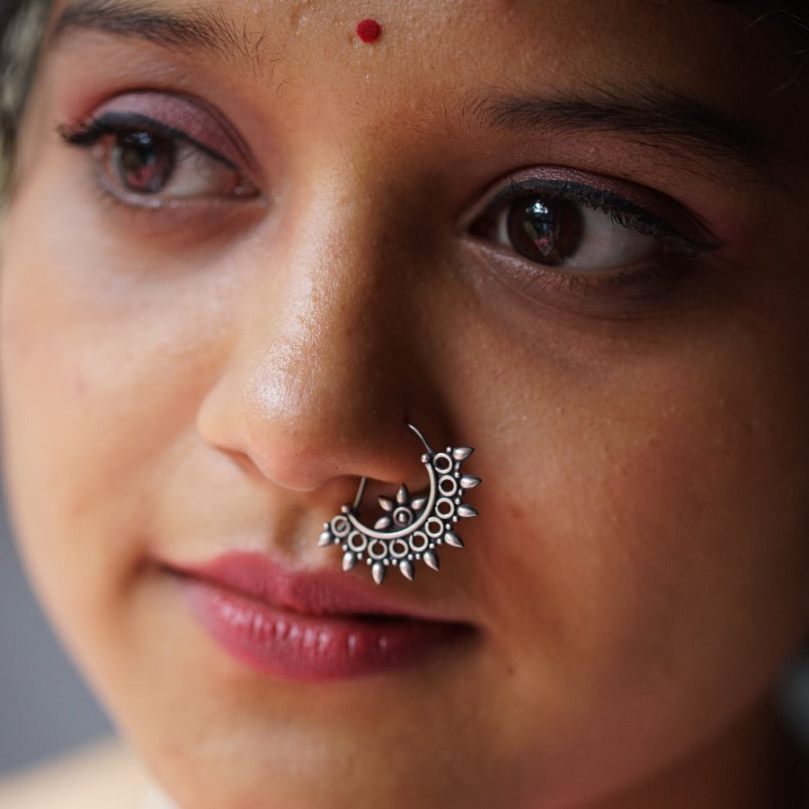 a close up of a woman with a nose ring