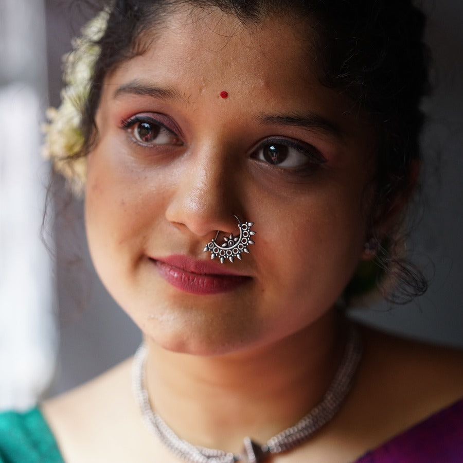 a close up of a woman with a nose ring