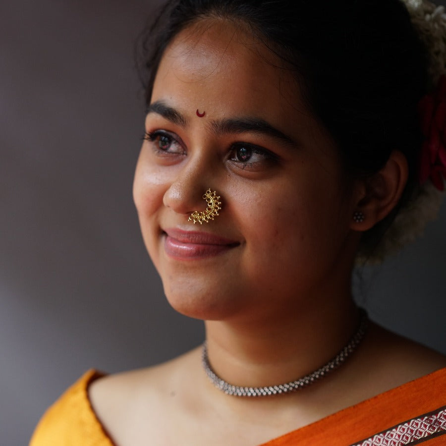 a woman with a nose ring and a necklace