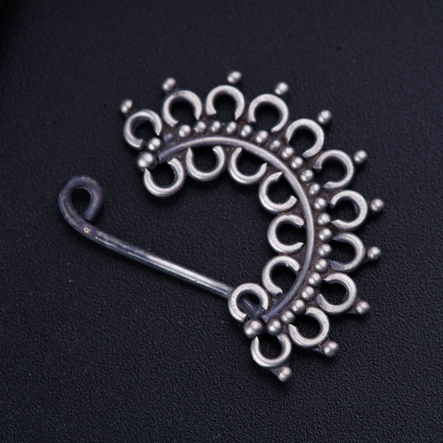 a metal brooch with a circular design on it