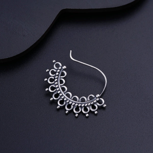 a close up of a pair of earrings on a black surface