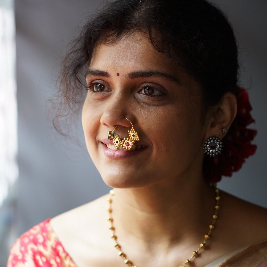 a woman with a nose ring and a necklace