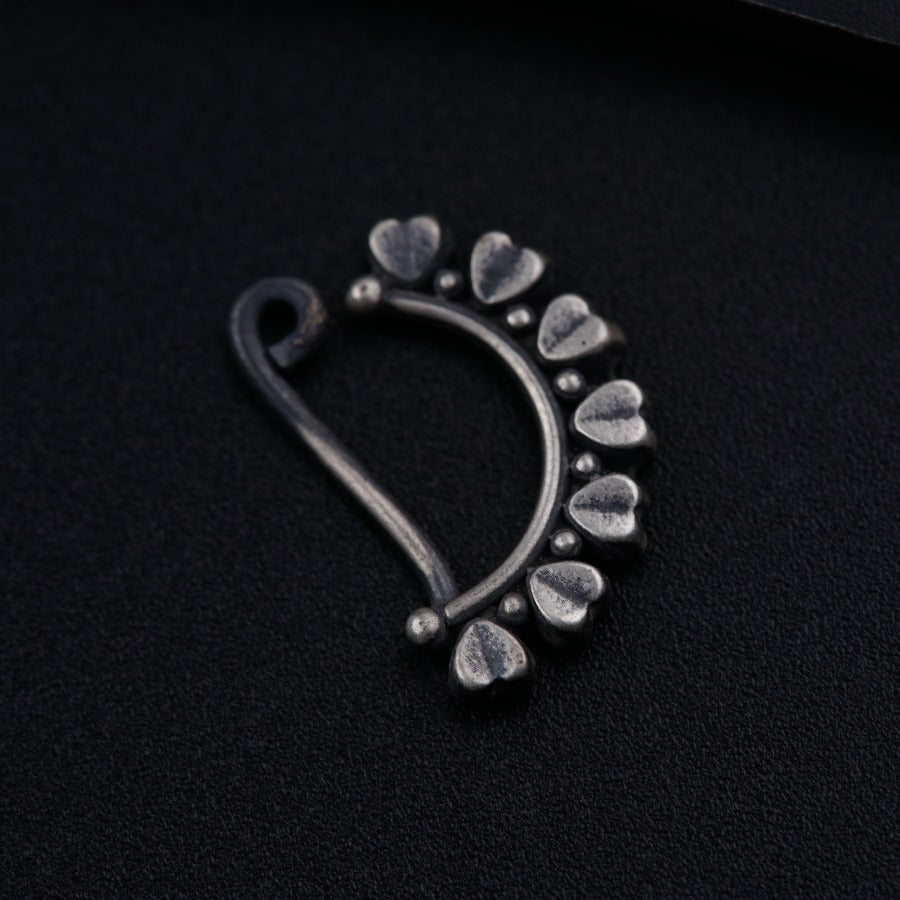 a close up of a metal object on a black surface
