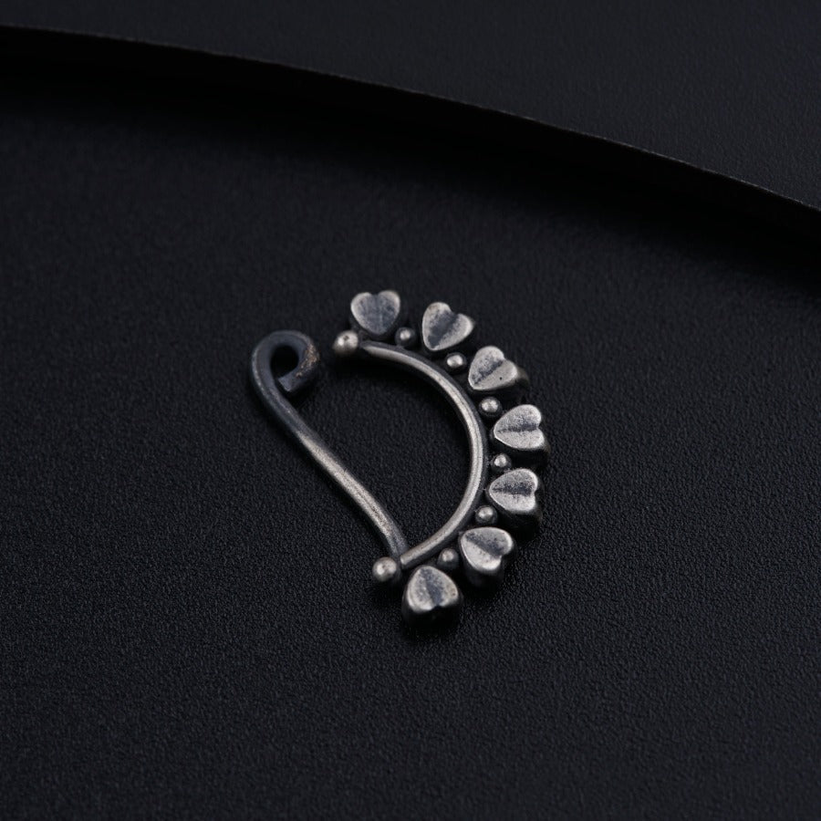 a close up of a metal object on a black surface