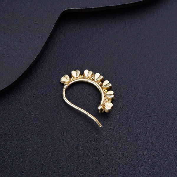 a close up of a brooch on a black surface