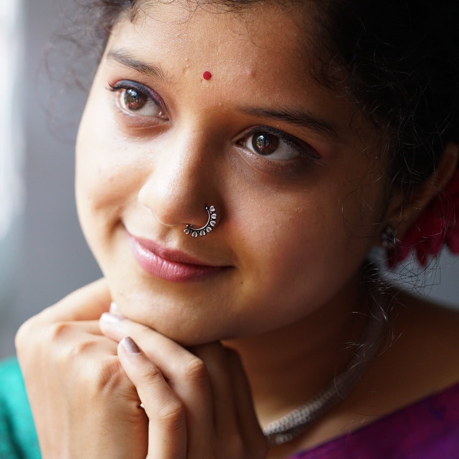 a woman with a nose ring and nose piercing