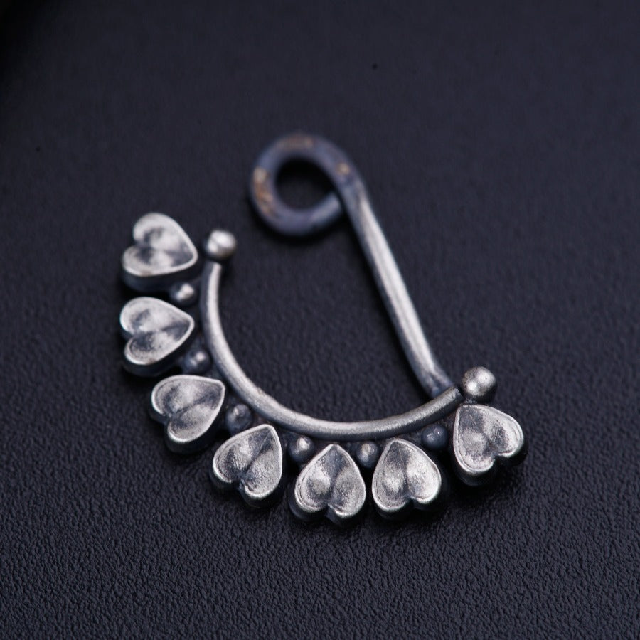 a close up of a metal hook with drops