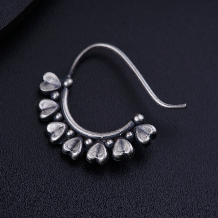 a close up of a pair of silver earrings