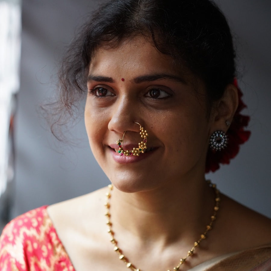 a woman with a nose ring on her nose