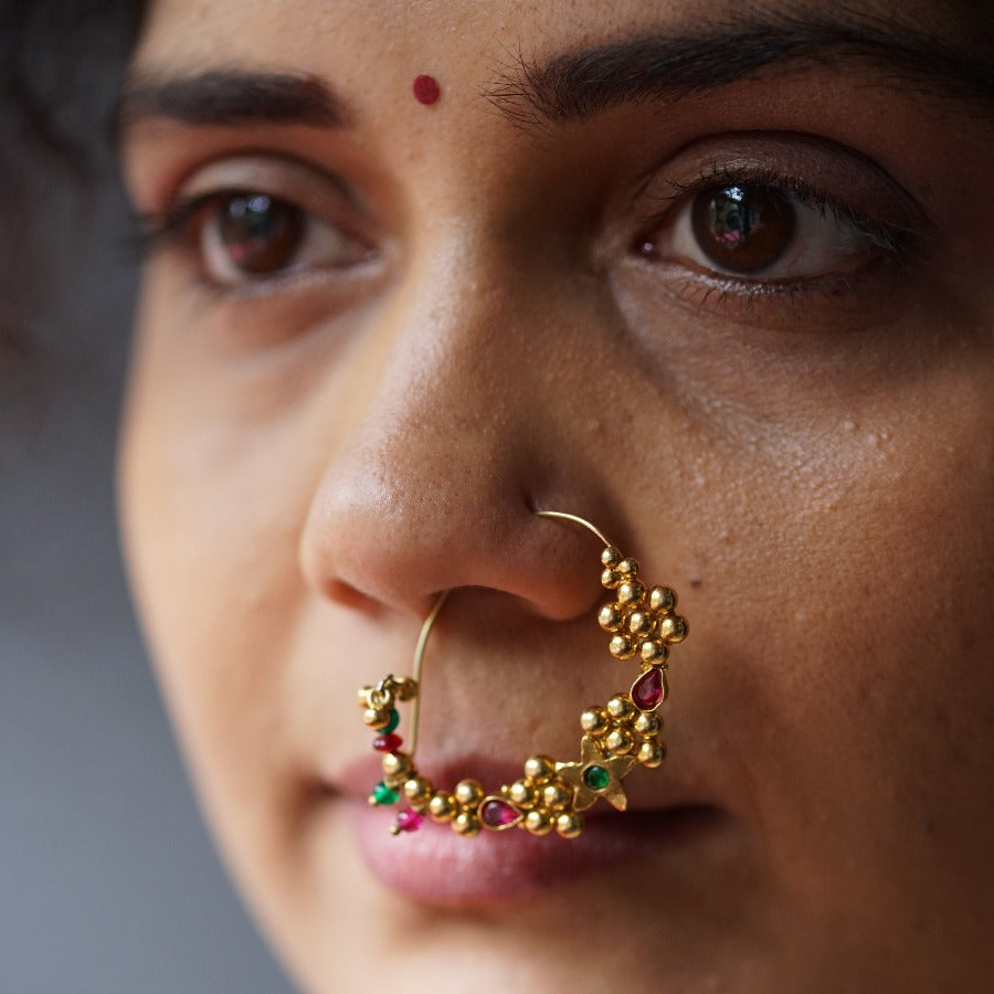 a close up of a woman with a nose ring