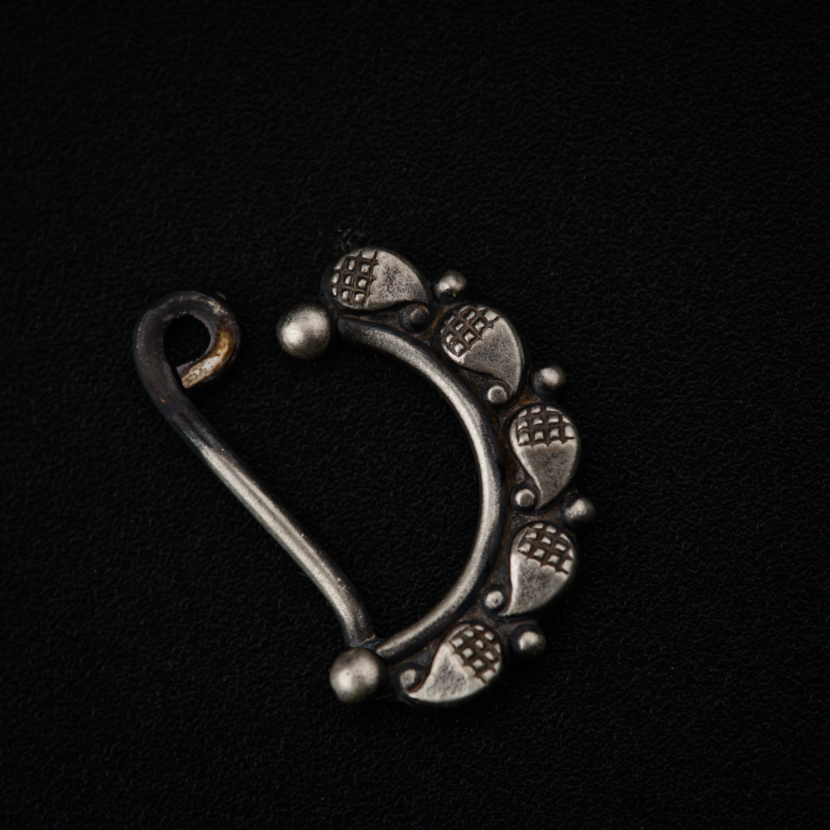 a metal hook with a design on it