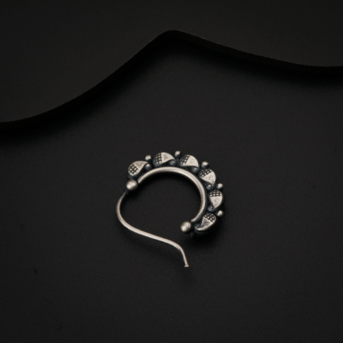 a black background with a pair of ear buds