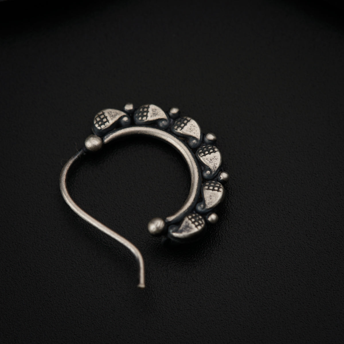 a close up of a metal object on a black surface