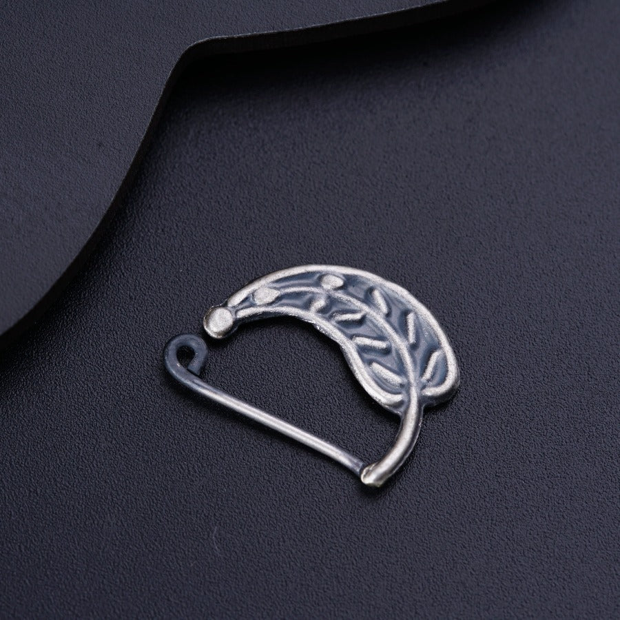 a piece of metal sitting on top of a black surface