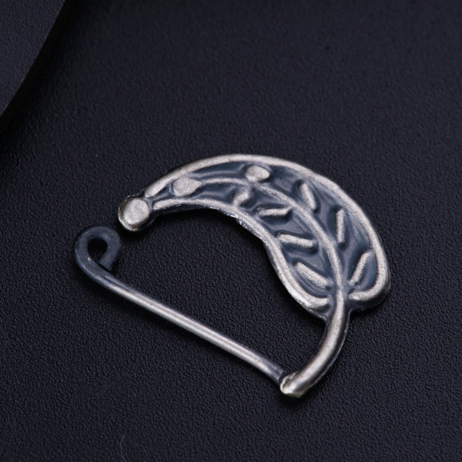 a silver brooch with a leaf design on it