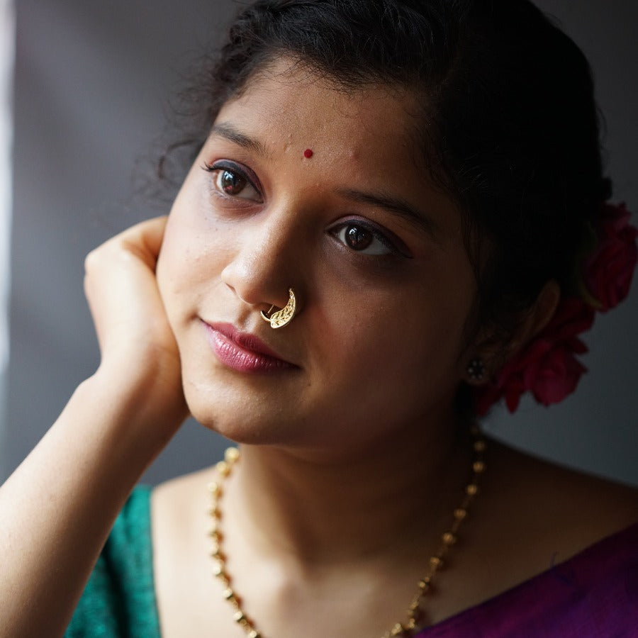 a woman with a nose ring on her nose