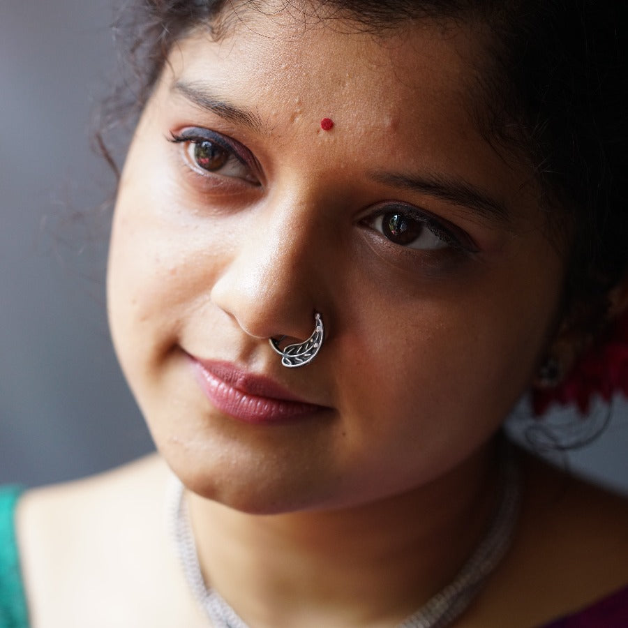 a close up of a woman with a nose ring
