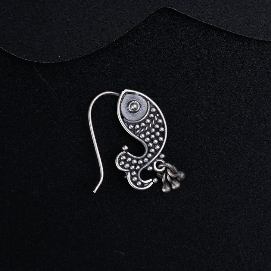 a close up of a metal object on a black surface