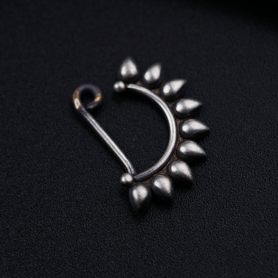 a close up of a metal object on a black surface