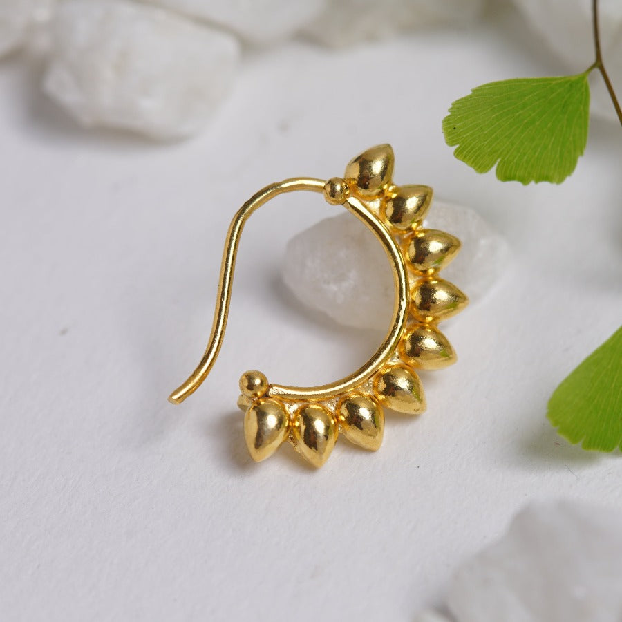 a close up of a pair of gold earrings