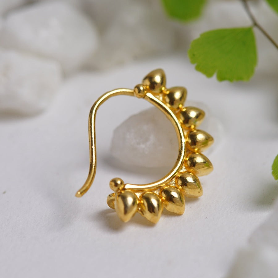 a close up of a pair of gold earrings